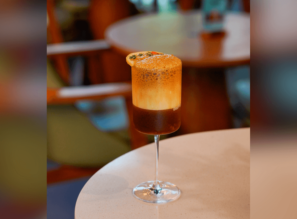 Pear Americano Champagne at Escape 360 Cafe in McKinney, a refreshing coffee-based beverage infused with pear flavor and topped with a sparkling twist for a unique, globally inspired drink experience.