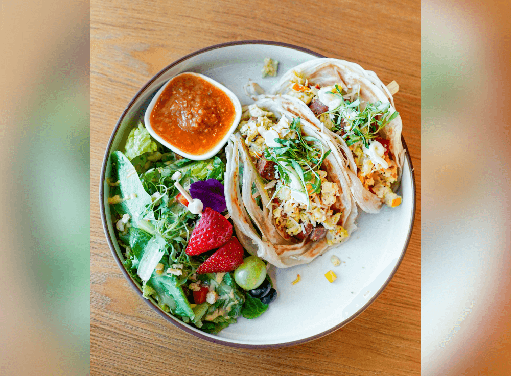 Sausage and Egg Wrap served with a fresh side salad at Escape 360 Cafe in McKinney, combining savory breakfast flavors with a crisp, healthy salad for a satisfying meal.