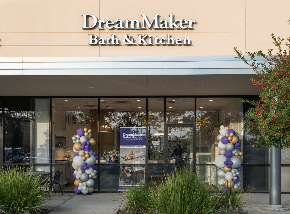 DreamMaker Bath & Kitchen design center in The Woodlands showcasing cabinetry, tile, countertops, and flooring samples for custom kitchen and bath projects.
