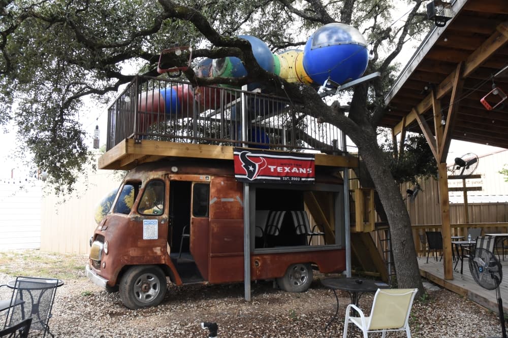 The image shows a playscape that stems form the inside of an old car. 
