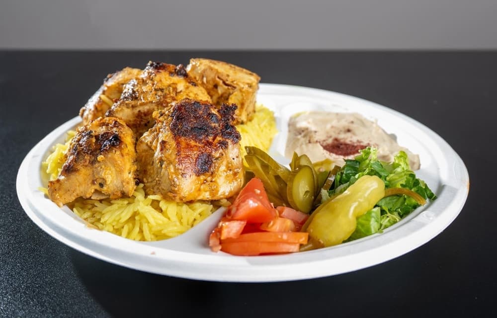 Hamilton's chicken kabob plate comes with halal grilled chicken and is served with hummus, rice, and a salad. (Courtesy Hamilton Mediterranean Grill & Pizza)