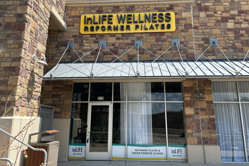 Exterior of a strip mall with InLife Wellness Reformer Pilates signage. 