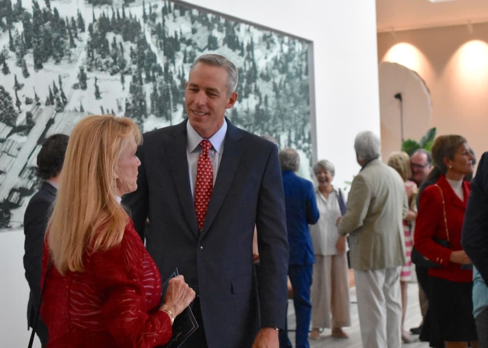 A man and woman talk at an event