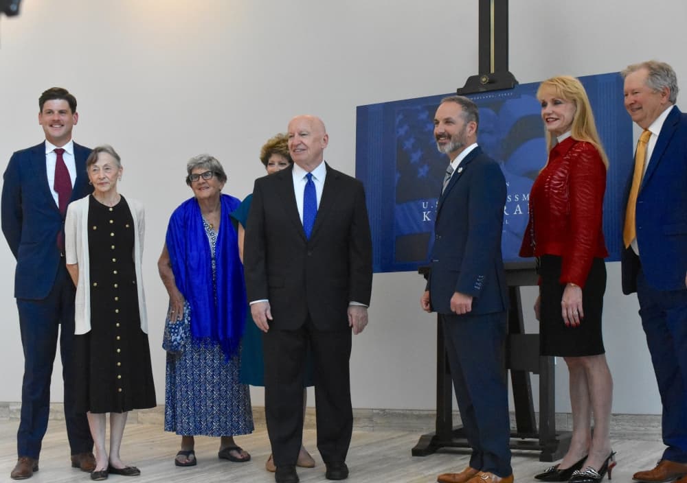 a row of people are gathered for a photo shoot