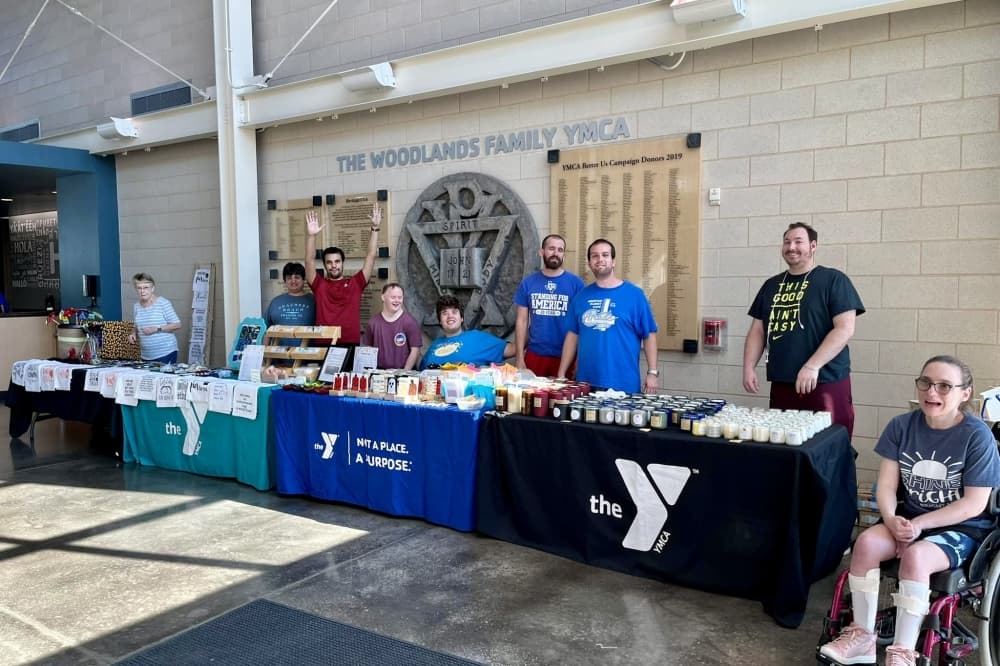 people at information tables for the YMCA