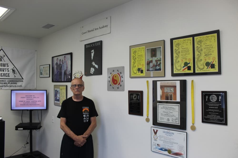 Grand Master Raymond Crow poses in the entrance to Crow's Martial Arts Academy
