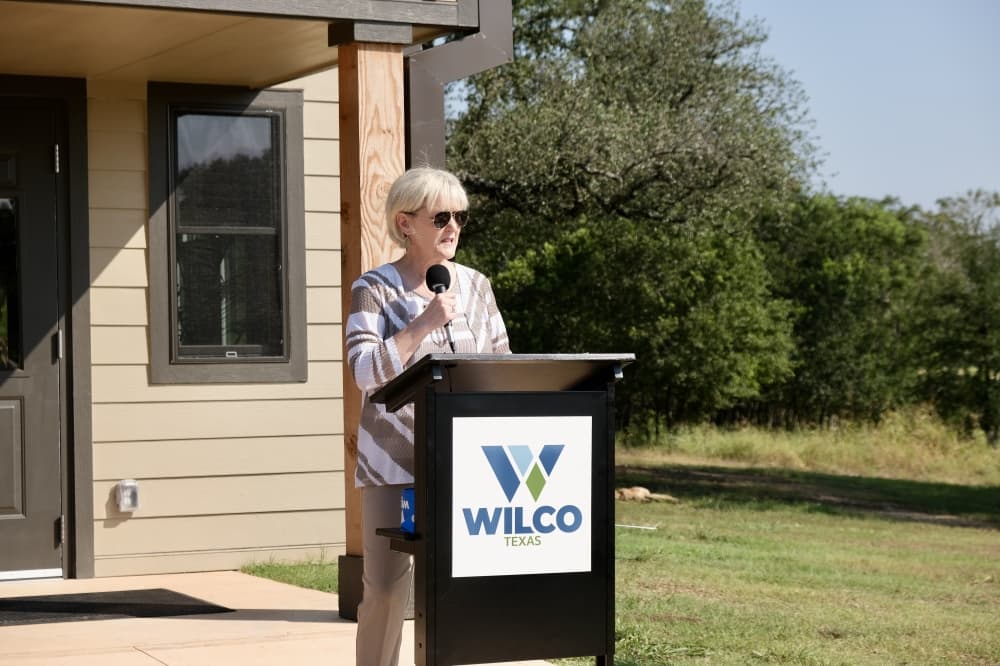 Valerie Covey speaks at a podium