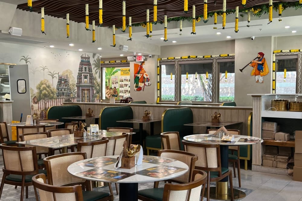 Interior of a restaurant featuring Indian cultural decorations. 