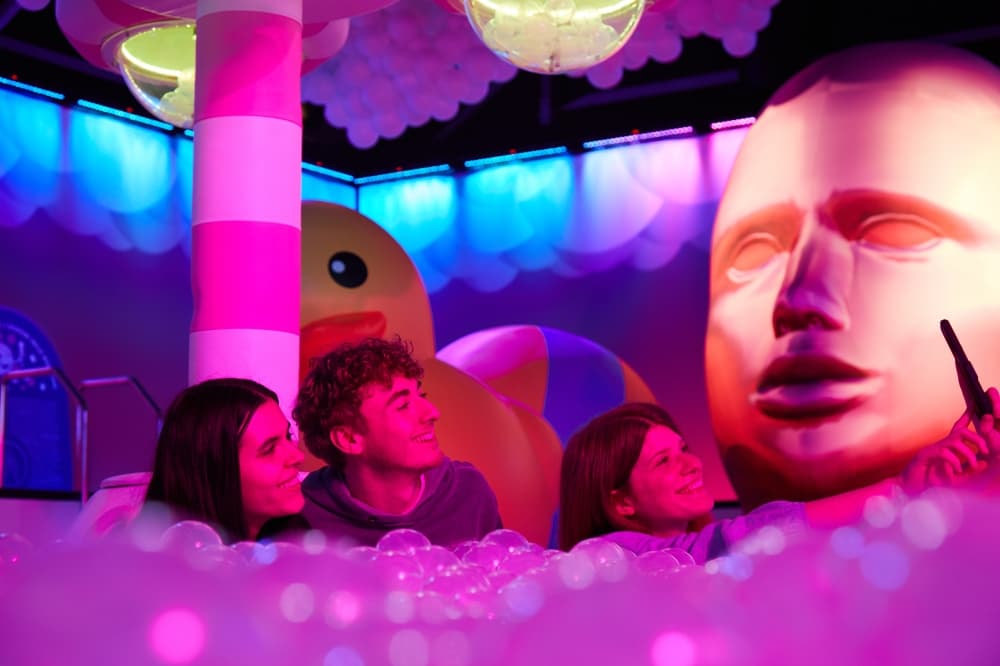 People in the bubble pit with a large rubber duck and floating head