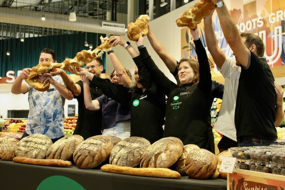 Group breaking bread loaves