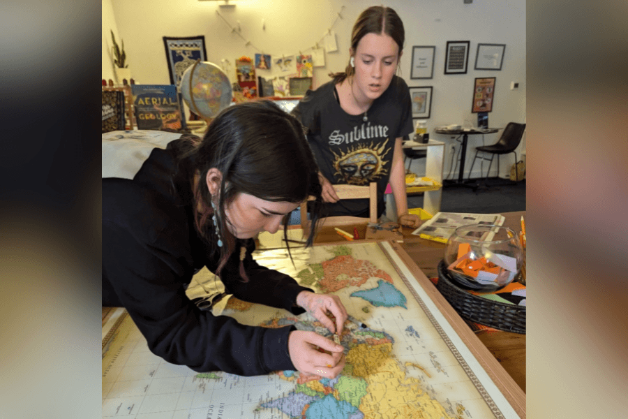 Middle school students at Mariposa Montessori School working together on a hands-on project in the classroom.