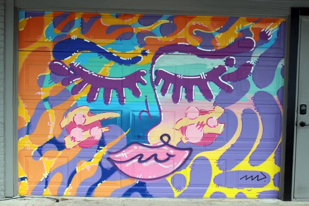 Bright abstract shapes in the background with elements of a person's face overlaid. 