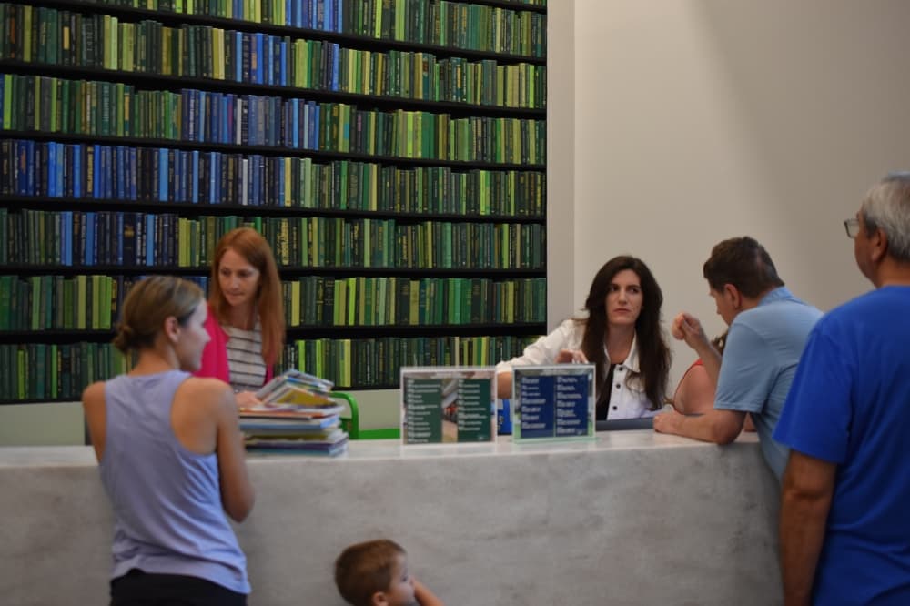 people at a library front desk