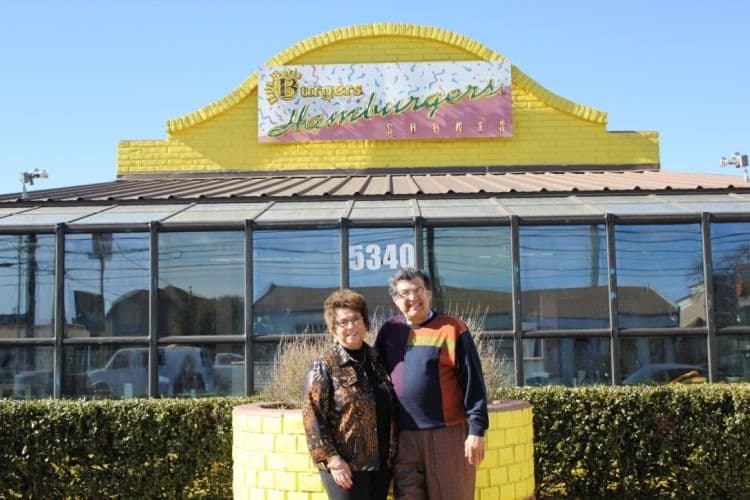 An image of the owners of the business in front of their current location. 