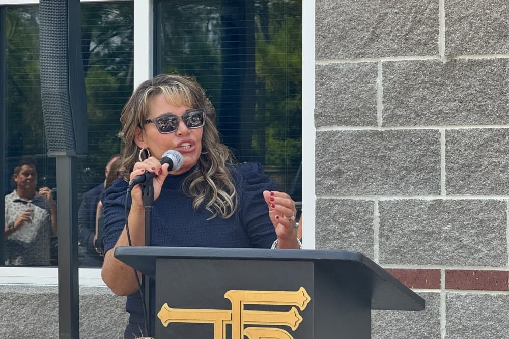 woman speaks at a podium