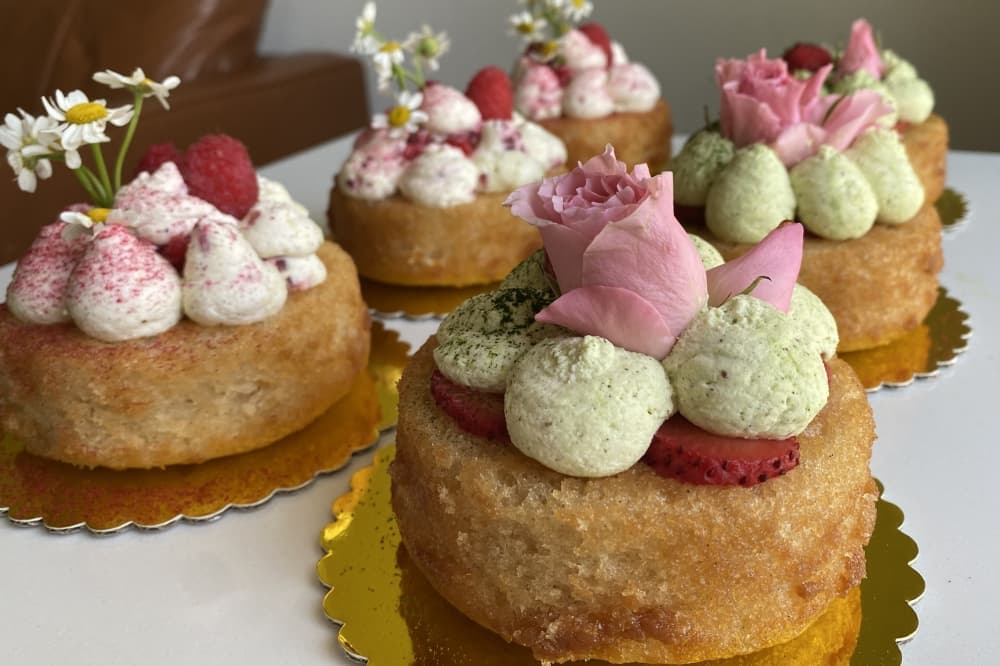 Sivaraju sells full-size and mini eggless cakes. Flavors include vanilla bean sponge cake with matcha whipped cream and fresh strawberries, as well as an almond sponge cake with fresh raspberry cream and fresh raspberries ($10 per mini cake). (Katlynn Fox/Community Impact)