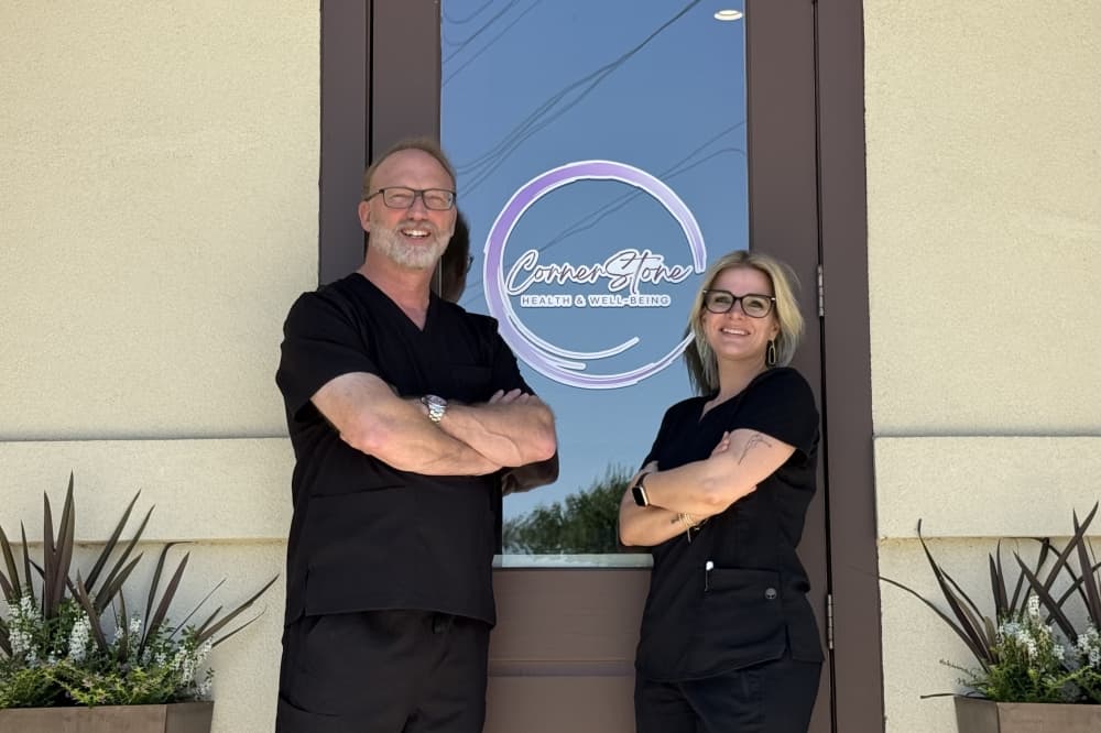 Cornerstone physician Dr. Chris McGee and founder Casie Coon pose at their storefront.