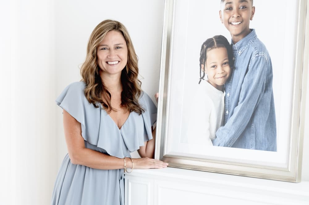 woman next to a framed photo