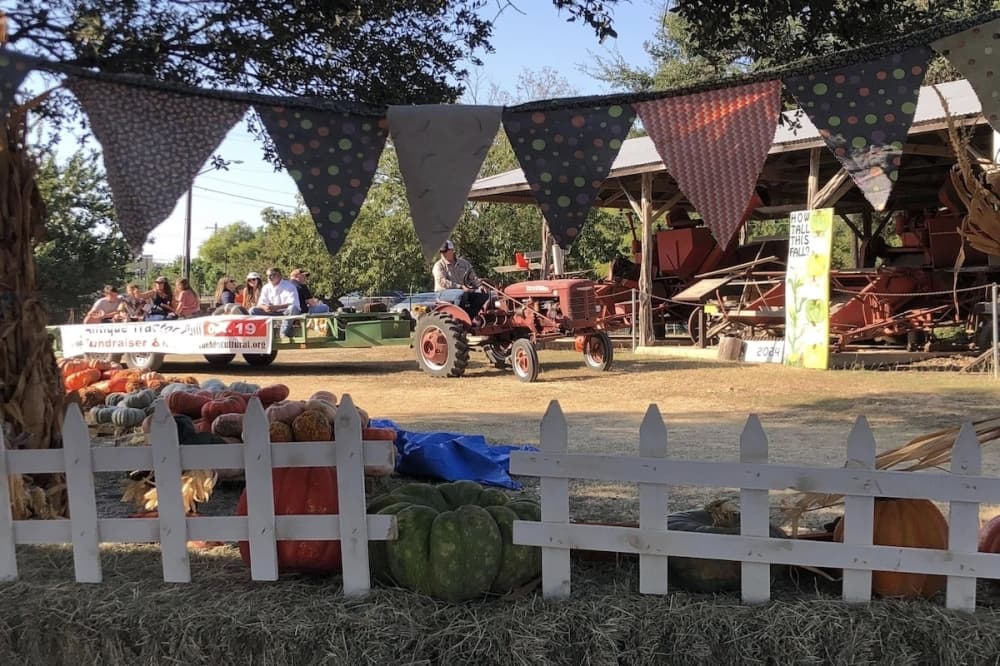A tractor races down a dirt road against the competition.
