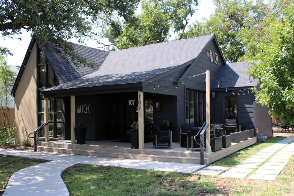 Exterior of a single-story house featuring black and brown design elements. 