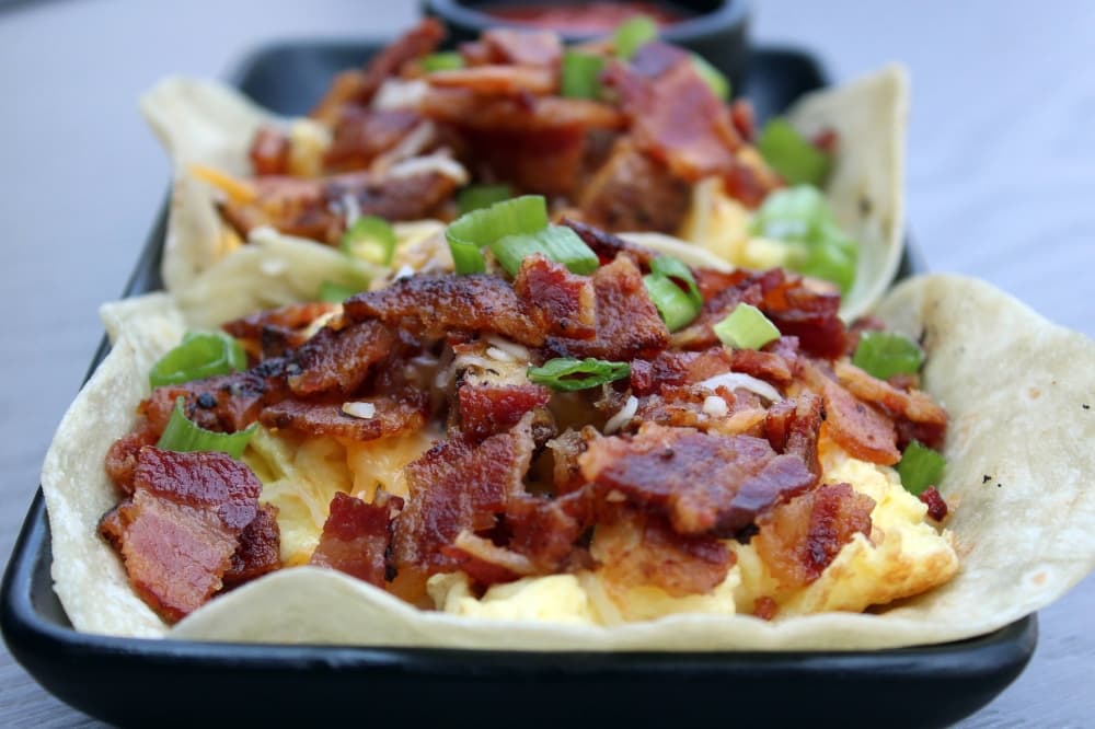 Two breakfast tacos on a tray. 