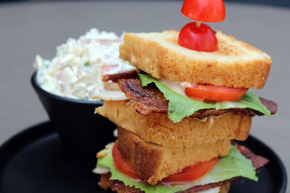Turkey club sandwich and side of potato salad. 