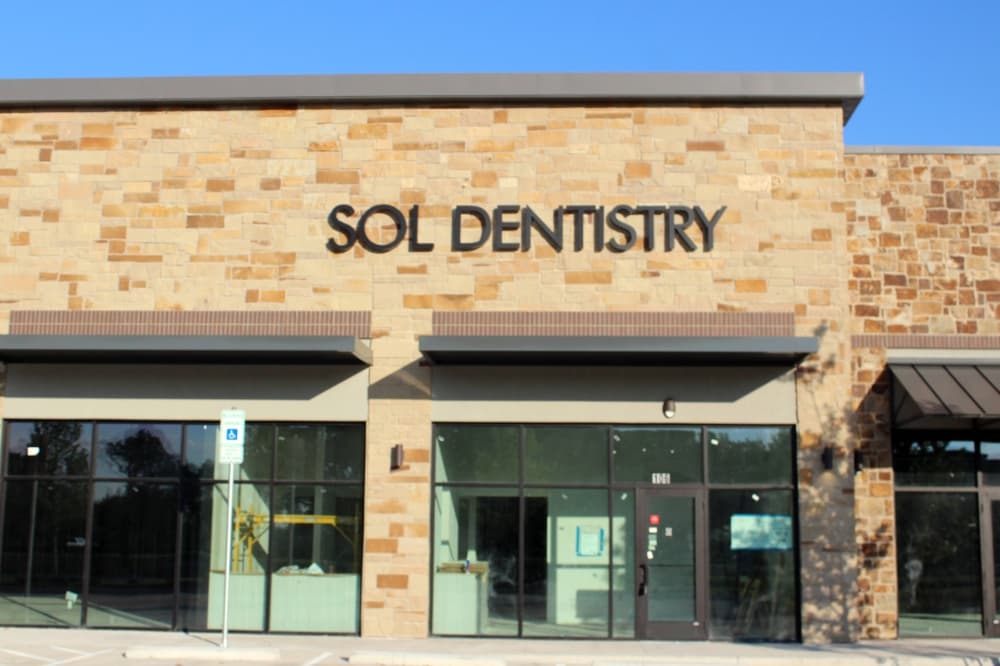 Exterior of a strip mall with Sol Dentistry signage. 