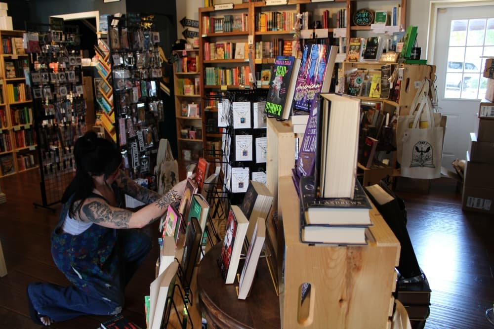 A TAB employee organizing books