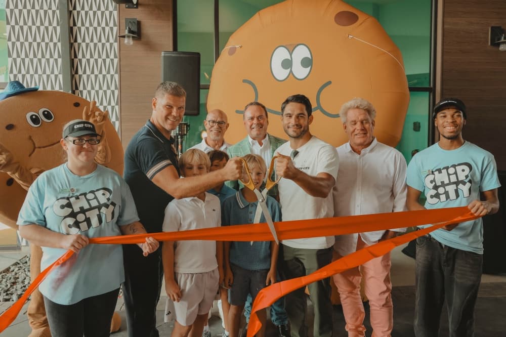 Group of people cutting a ribbon