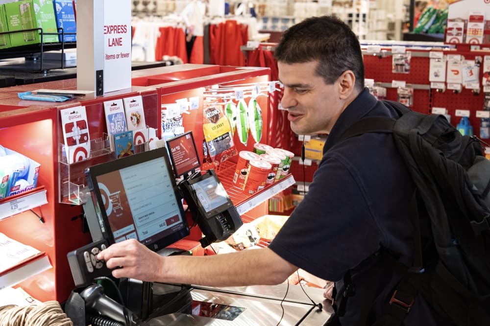 person uses a self checkout kiosk at target