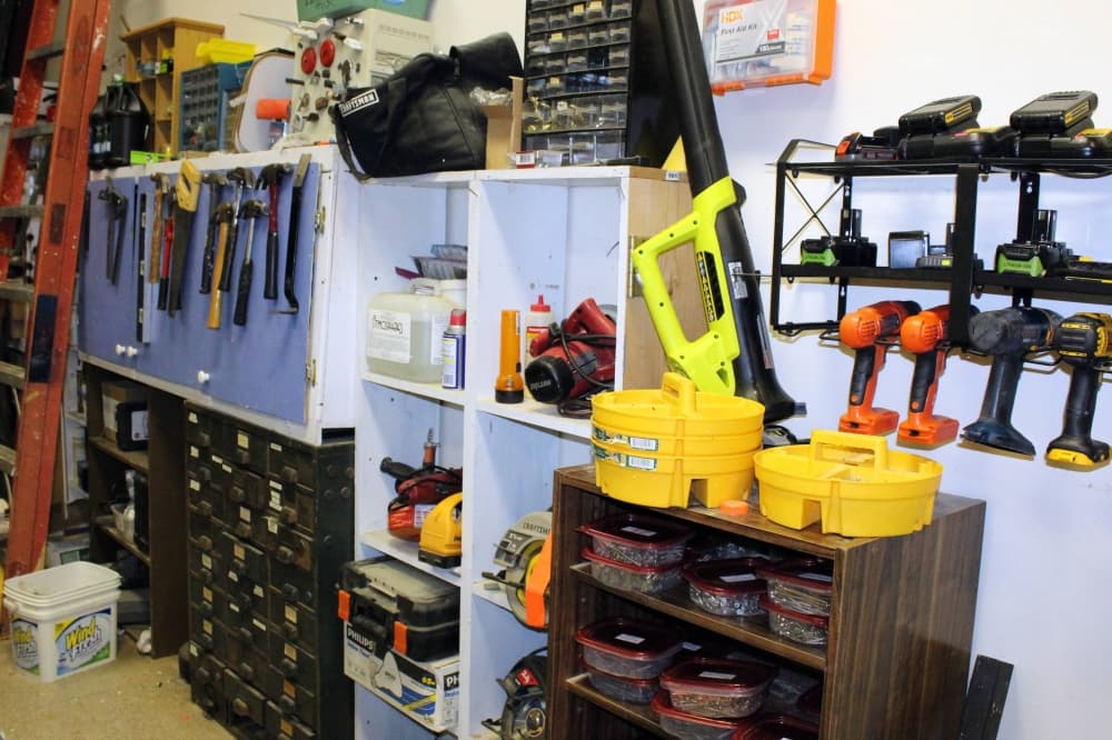 Tools hanging on a wall and on shelves.