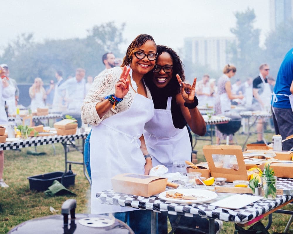 An image of two people participating in the hands-on grilling session. 