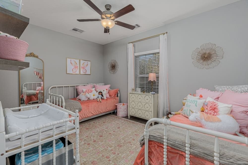 a bedroom with three beds