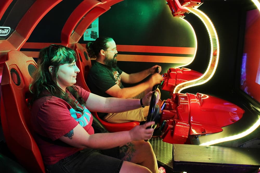 Male and female playing an arcade game. 