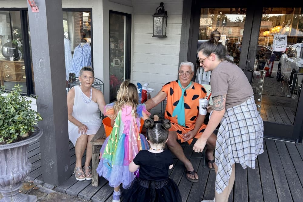 kids in halloween costumes on a house porch