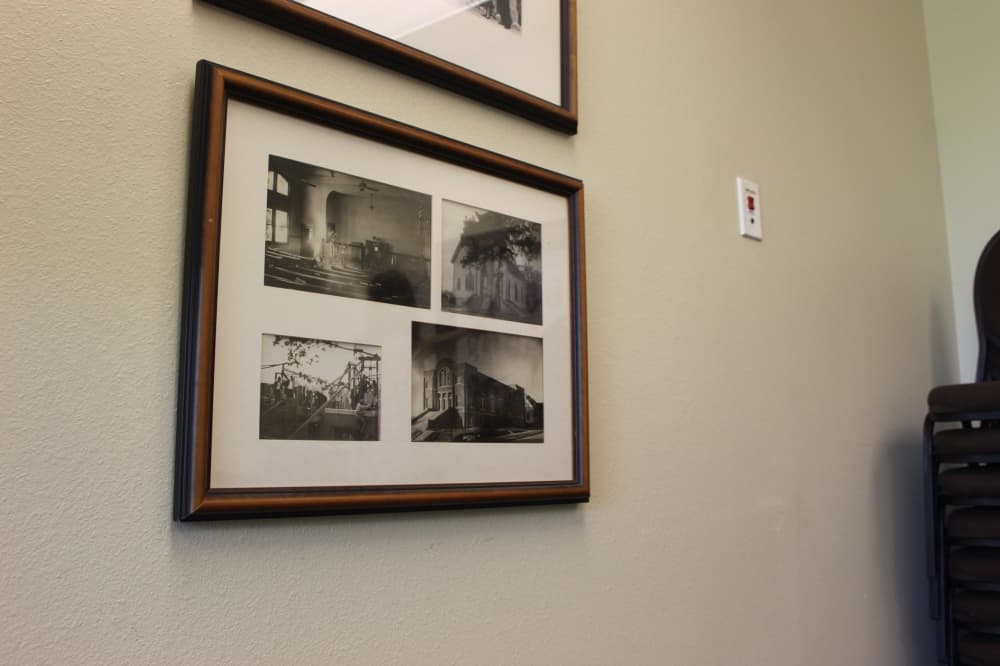 Image of a framed photo showing Trinity Presbyterian Church's previous buildings. 