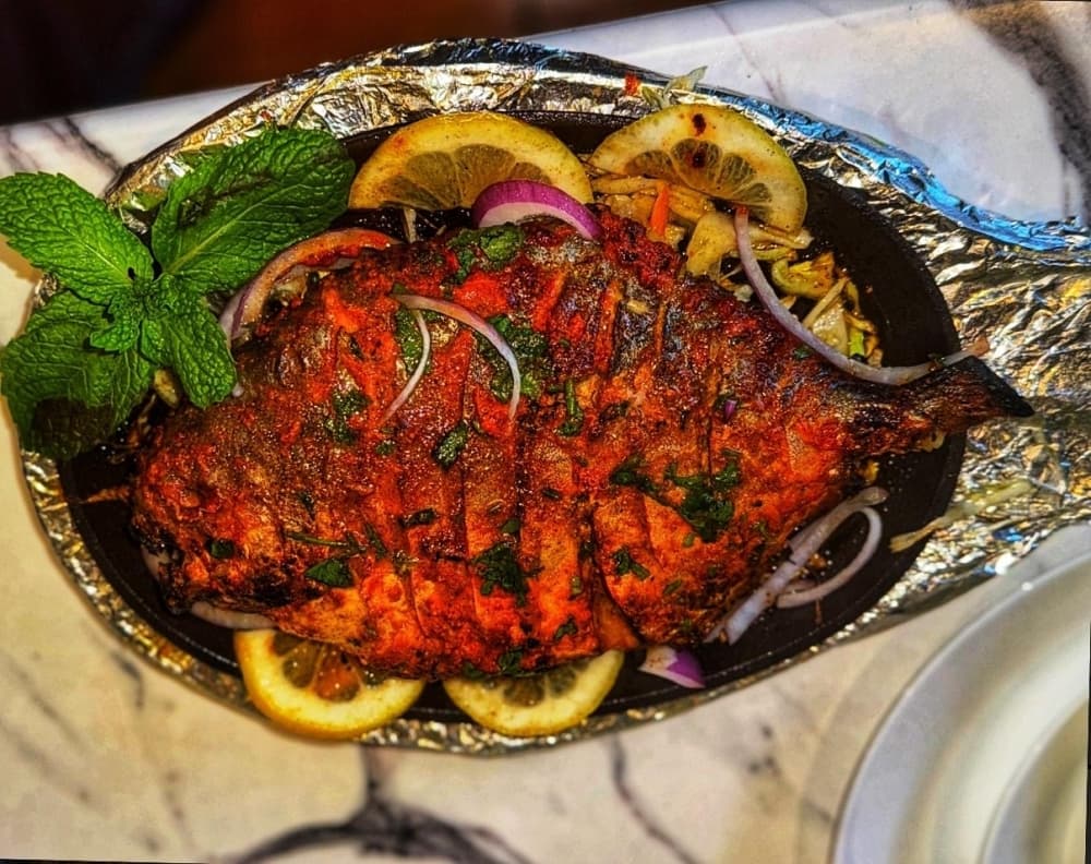 The Tandoori Pompano is a spiced seafood dish served with lemon wedges for $17.99. (Courtesy Tikka House)