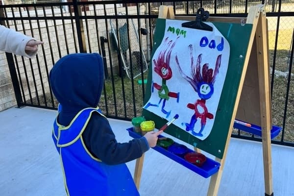 A photo of students completing art projects outside