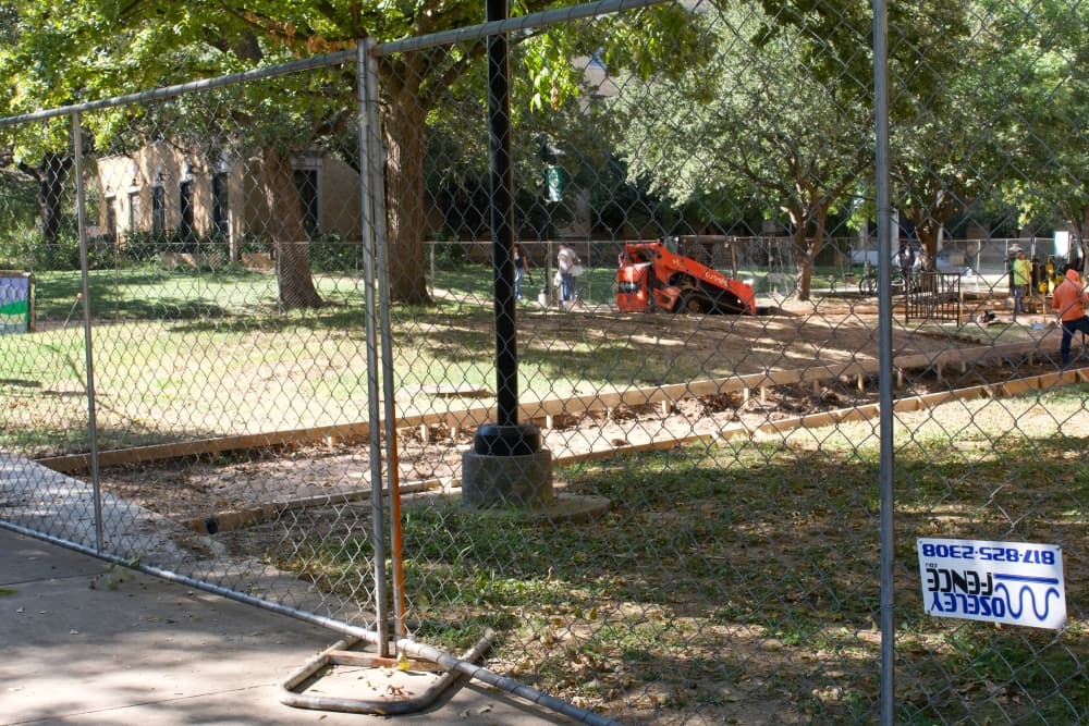 Construction workers laying down inftrastructure to instsall a new sidewalk.