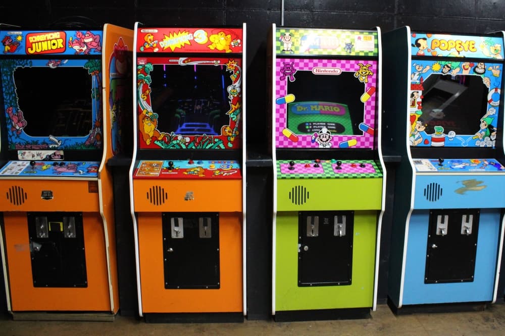 Mario, Donkey Kong and other video game consoles standing next to each other. 