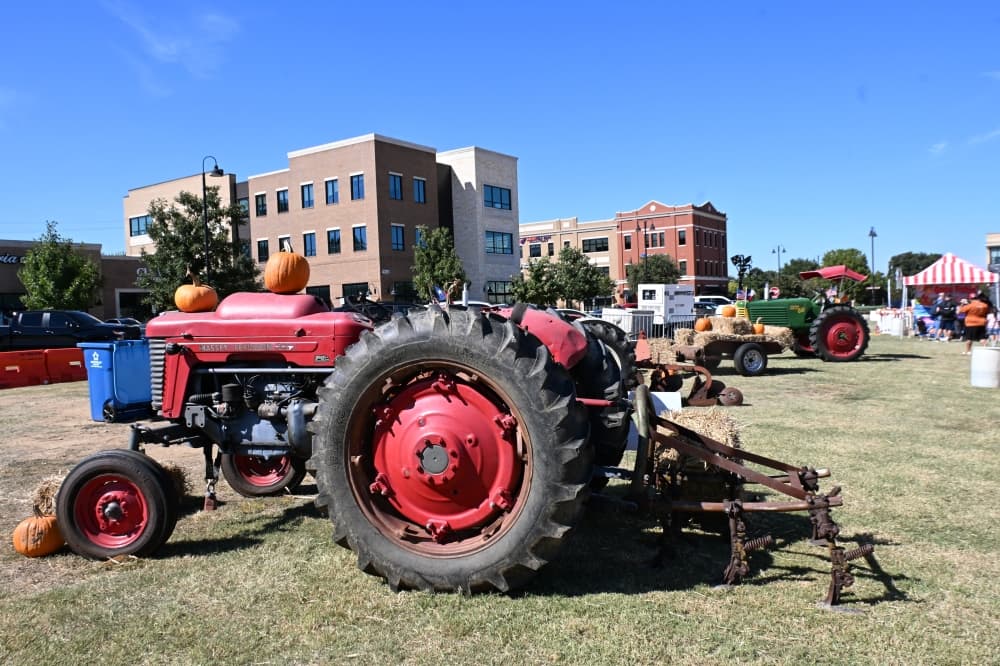 Several vintage tractors in a line
