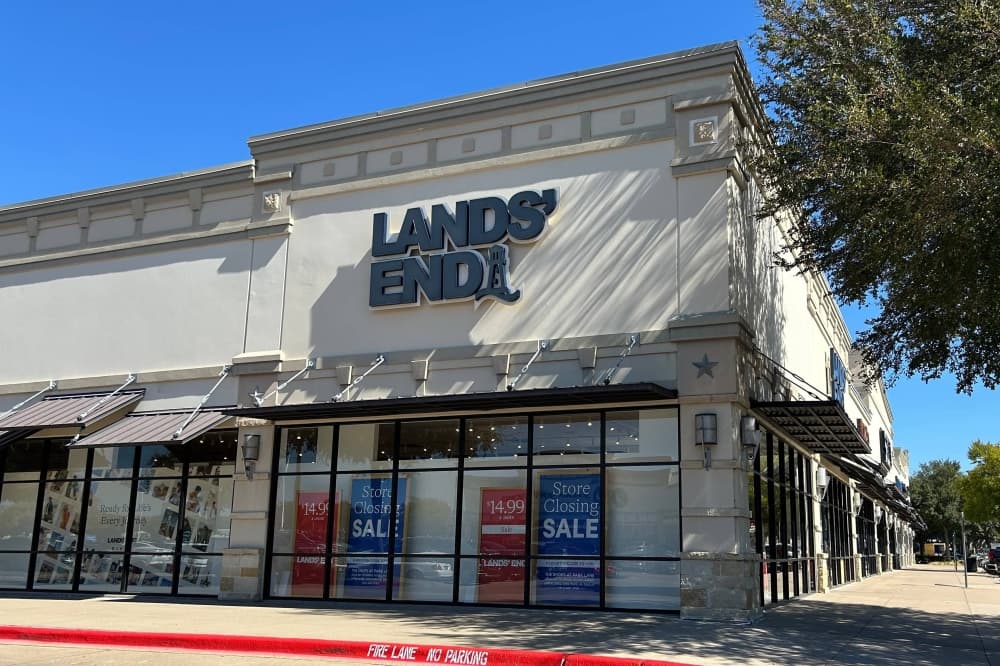 Exterior of corner business in a strip mall featuring Lands' End signage. 