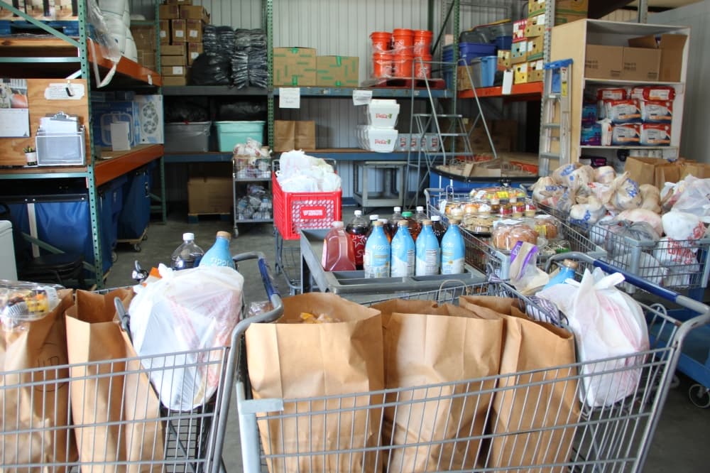 shopping carts and shelves are filled with bags of household items