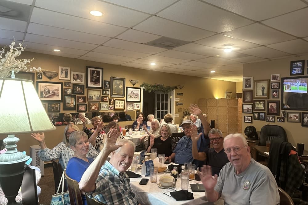 people sitting at a group table in a restaurant