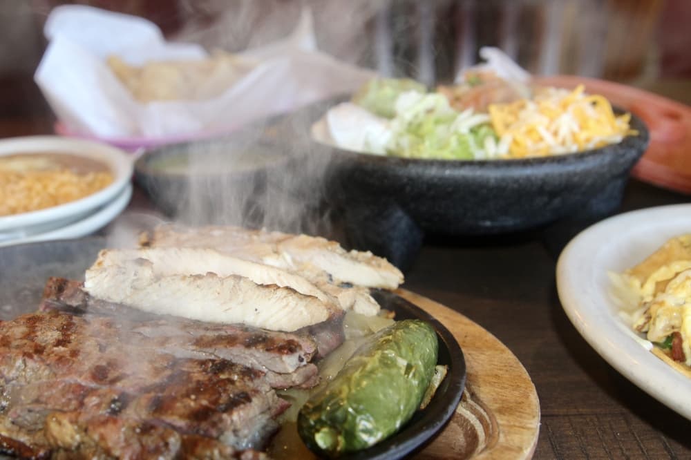 La Margarita offers a range of Tex Mex dishes including the mixed fajitas for one which comes with beef and chicken fajitas, guacamole, sour cream, grated cheese, pico de gallo, rice and refried beans ($24.95). (Katlynn Fox/Community Impact)
