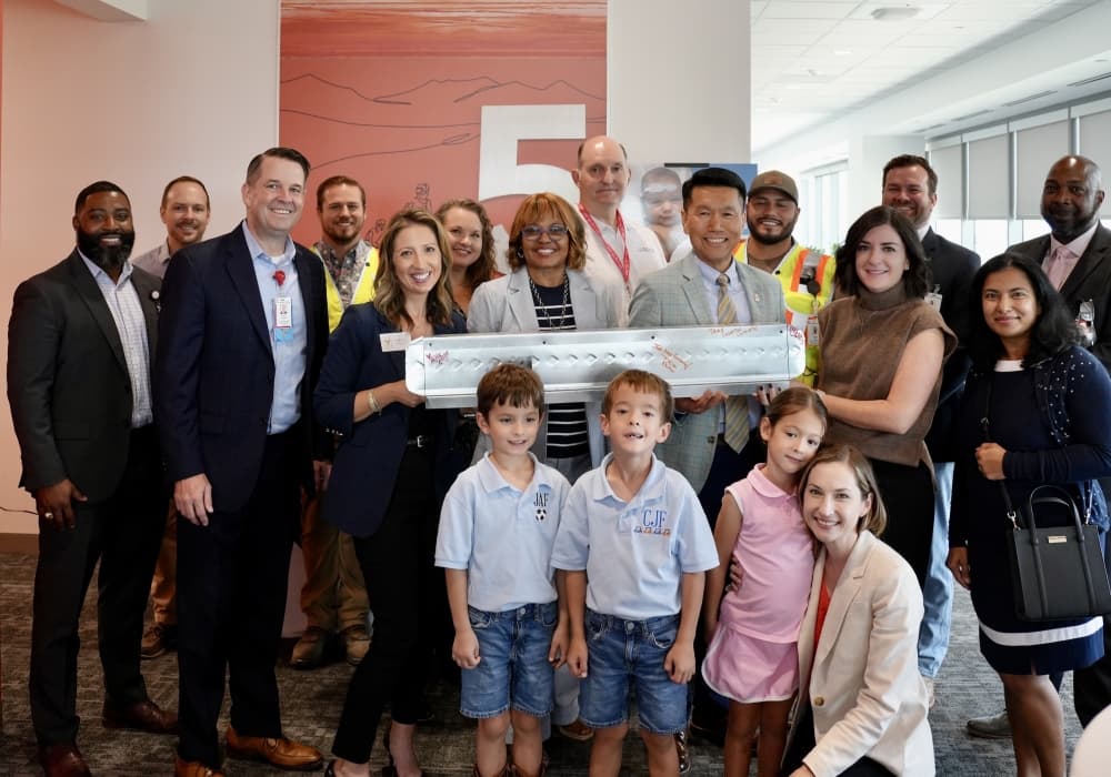An image of the team and an impacted family at the event. 