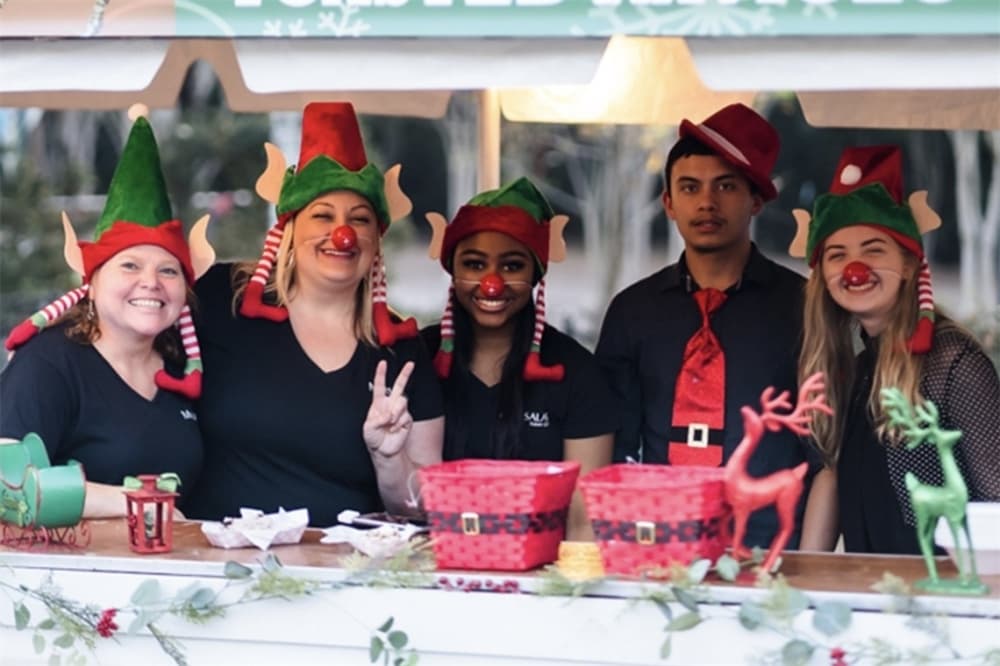 holiday decorations and people dressed like elves