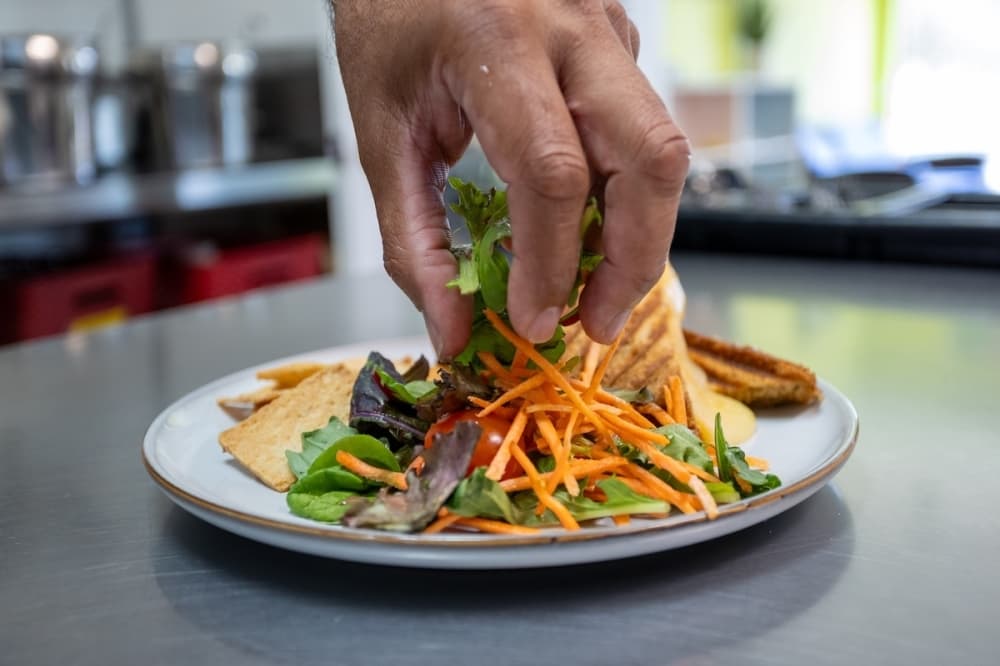 Naturally Cafe in Gruene Lake Village, New Braunfels, plates up salad for new test dish.