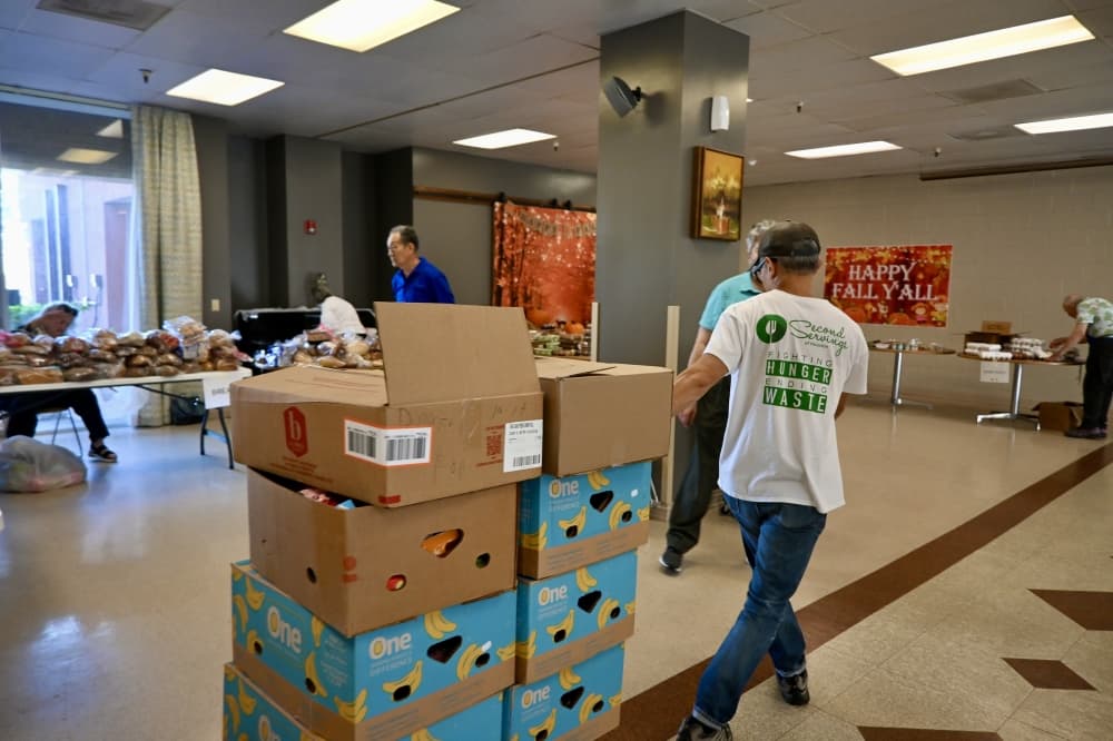 a person pulls a stack of boxes filled with food