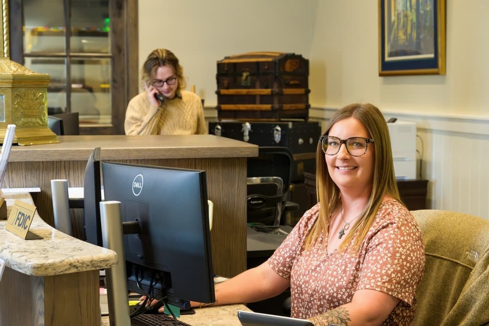Hutto banker smiling at computer